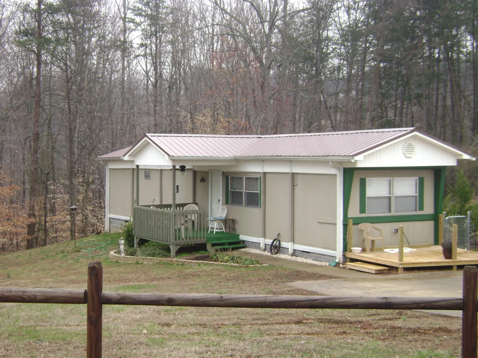 Mauve metal roof on a manufactured home with a new front deck in Plantation